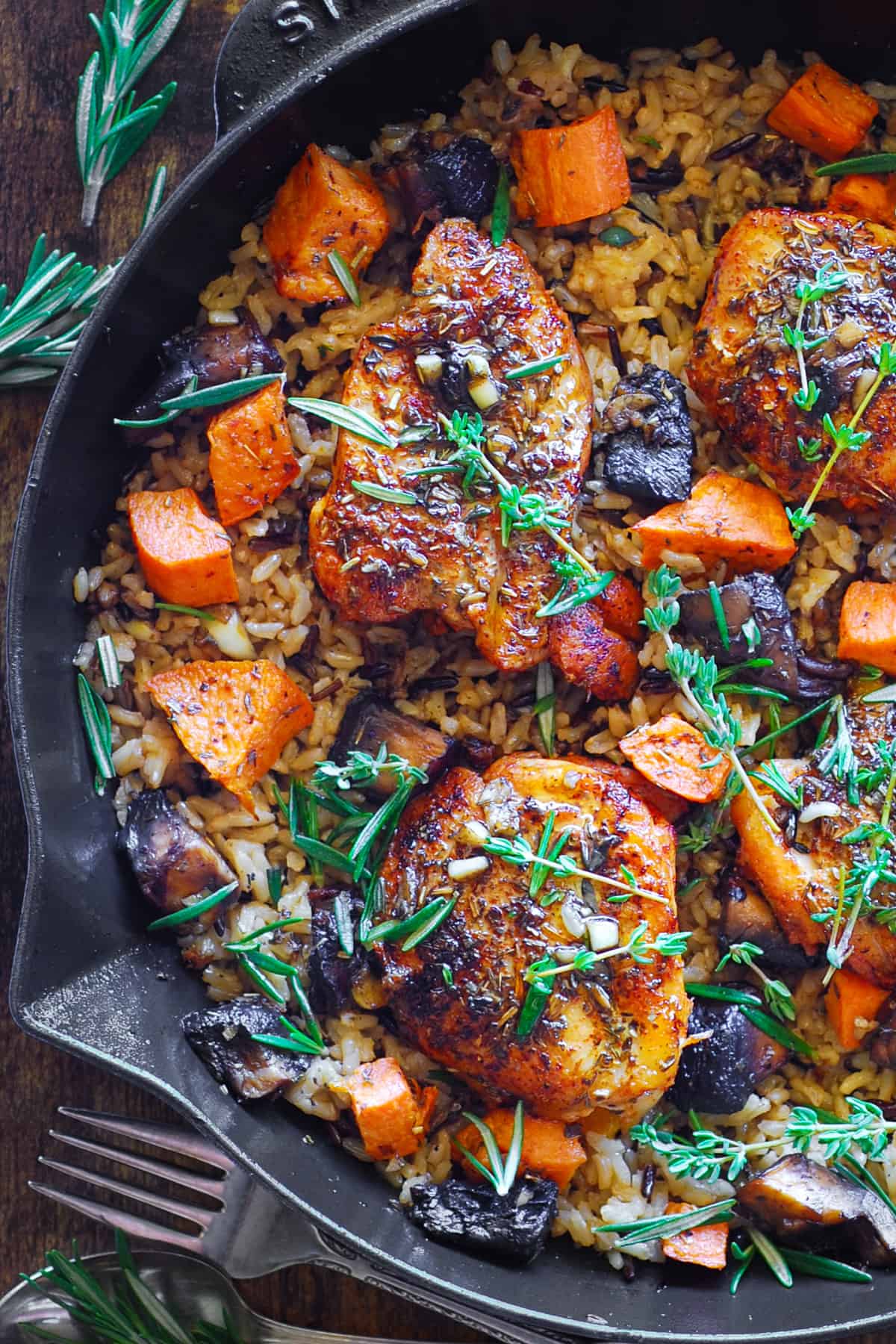 Chicken Wild Rice with Sweet Potatoes and Mushrooms in a cast iron skillet.