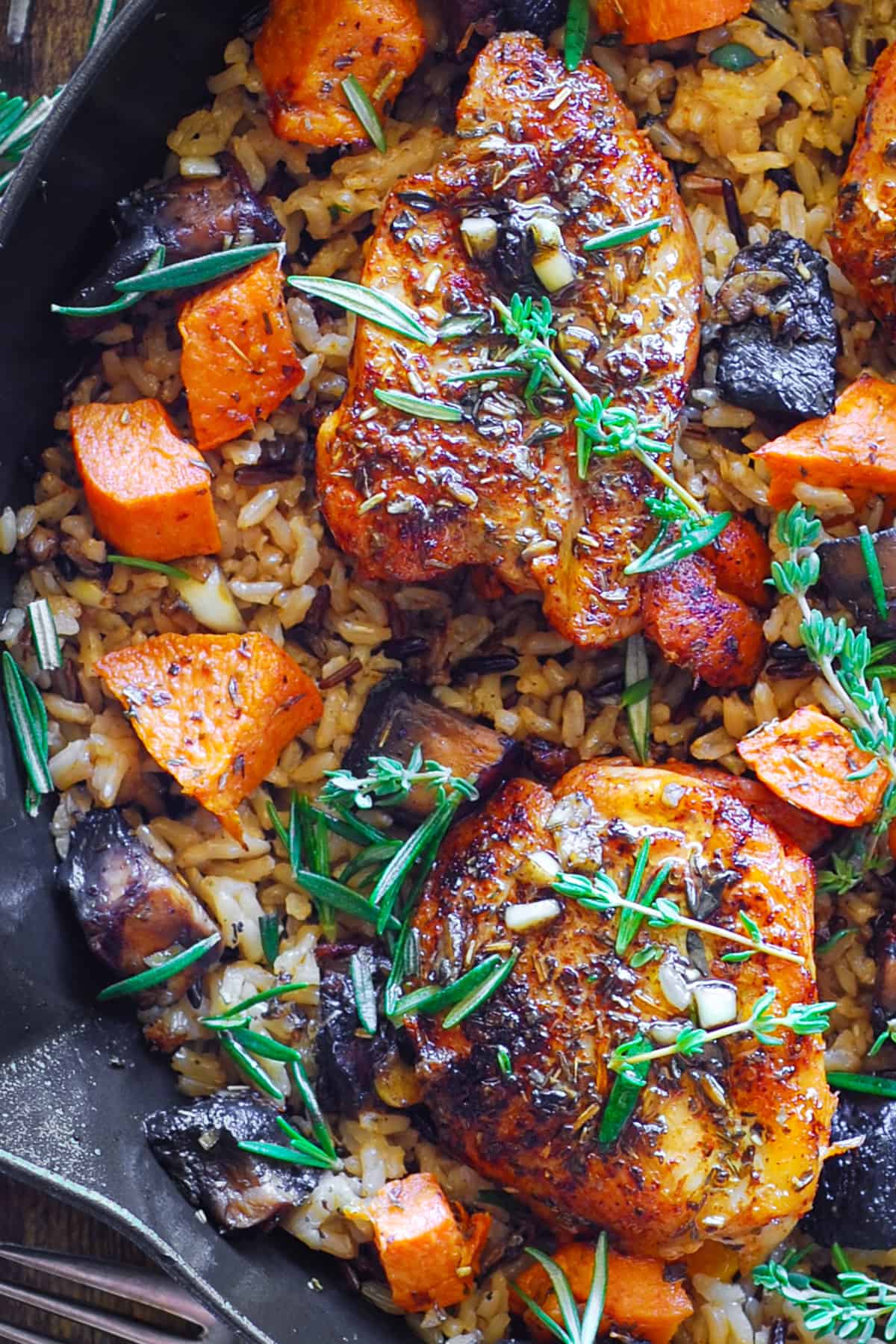 Chicken Wild Rice with Sweet Potatoes and Mushrooms in a cast iron skillet.
