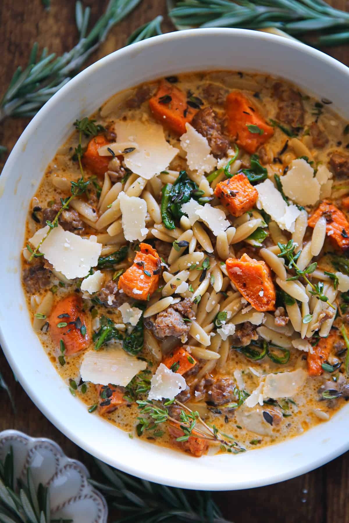 Creamy Butternut Squash and Sausage Soup with Orzo and Spinach topped with shaved Parmesan