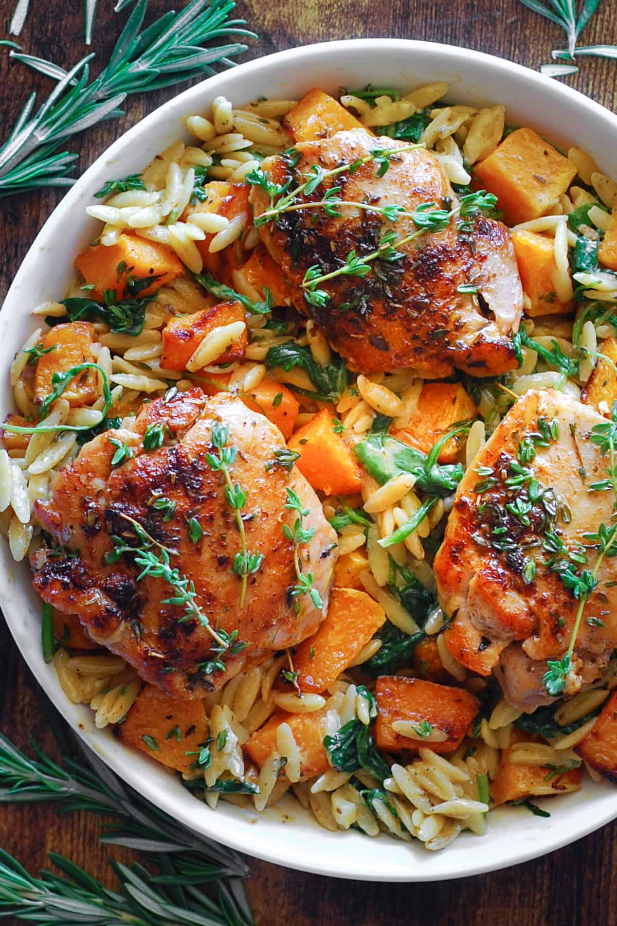 Chicken Orzo with Butternut Squash and Spinach in a white bowl.