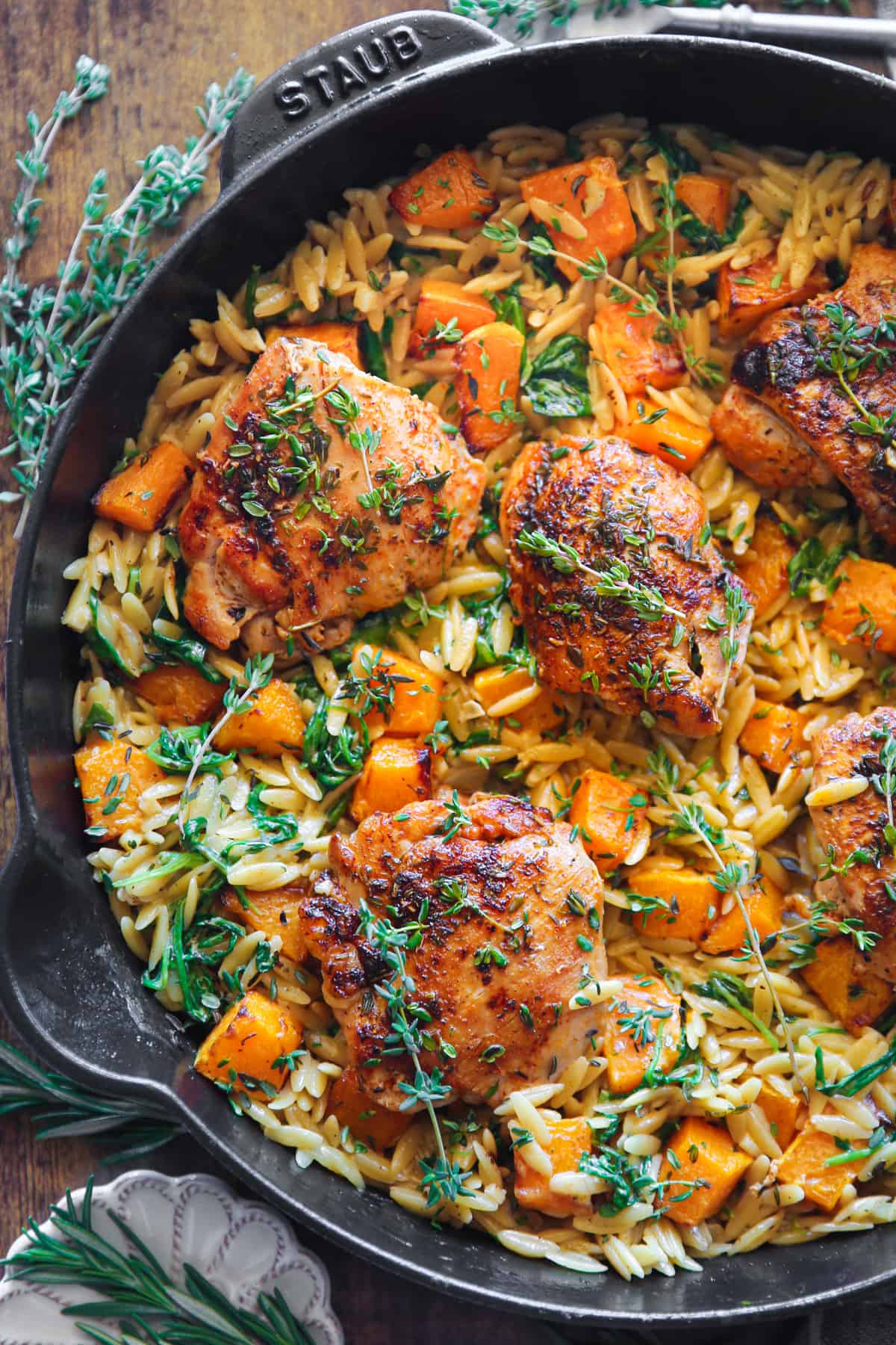 Chicken Orzo with Butternut Squash and Spinach in a cast iron skillet.