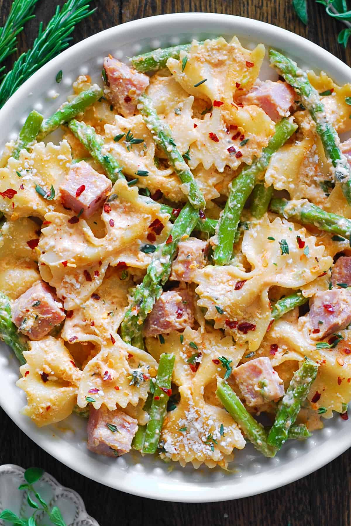 Creamy Ham Pasta with Asparagus on a white plate.