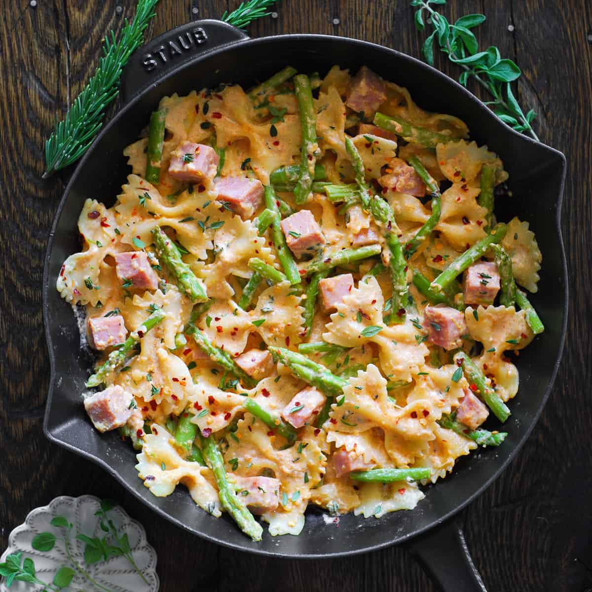 Creamy Ham Pasta with Asparagus in a cast iron pan.