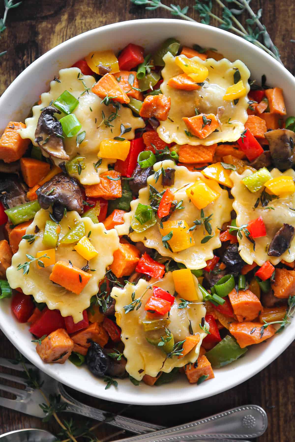 Ravioli with Sweet Potatoes, Portobello Mushrooms, Bell Peppers in a white bowl.