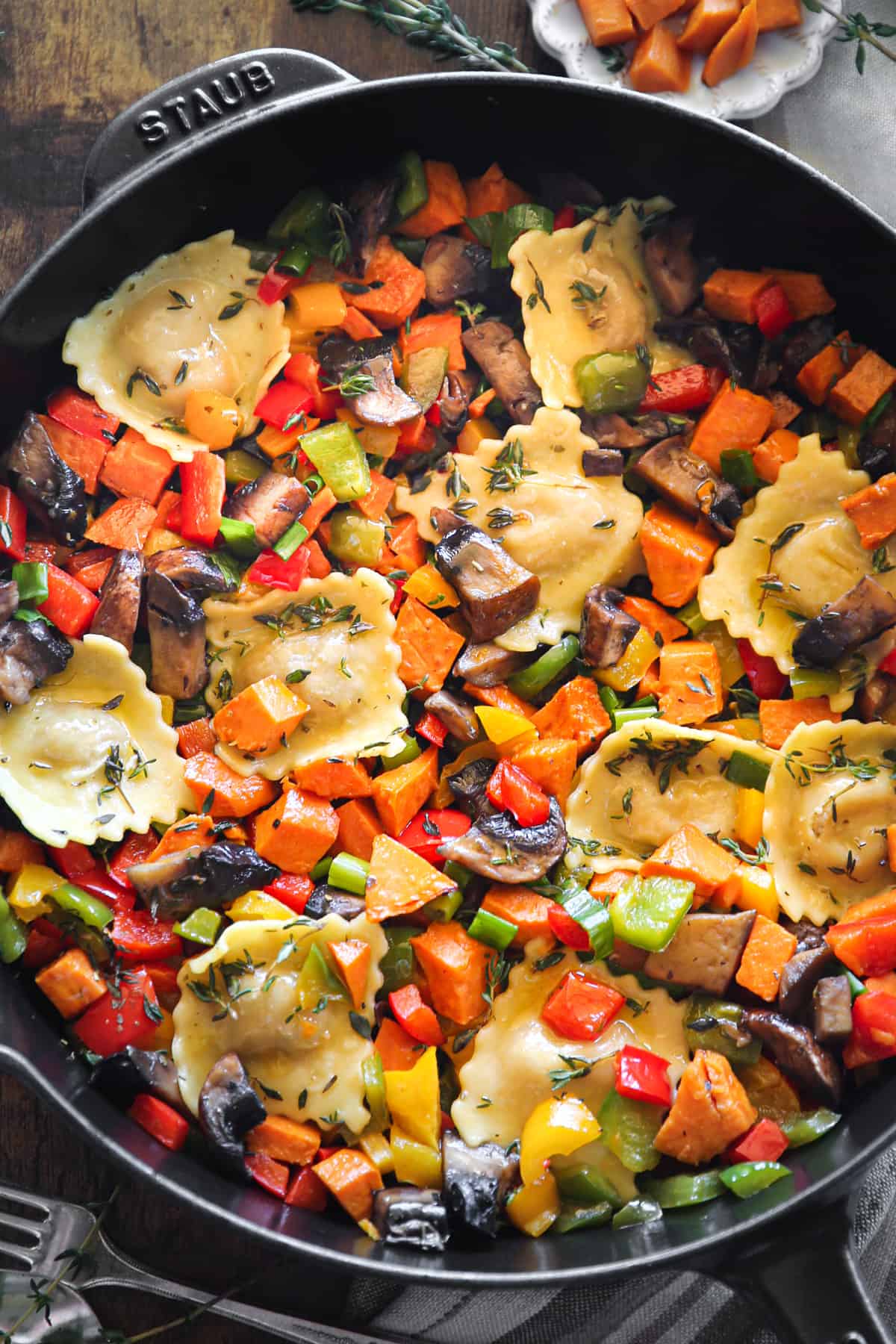 Ravioli with Sweet Potatoes, Portobello Mushrooms, Bell Peppers in a cast iron skillet.
