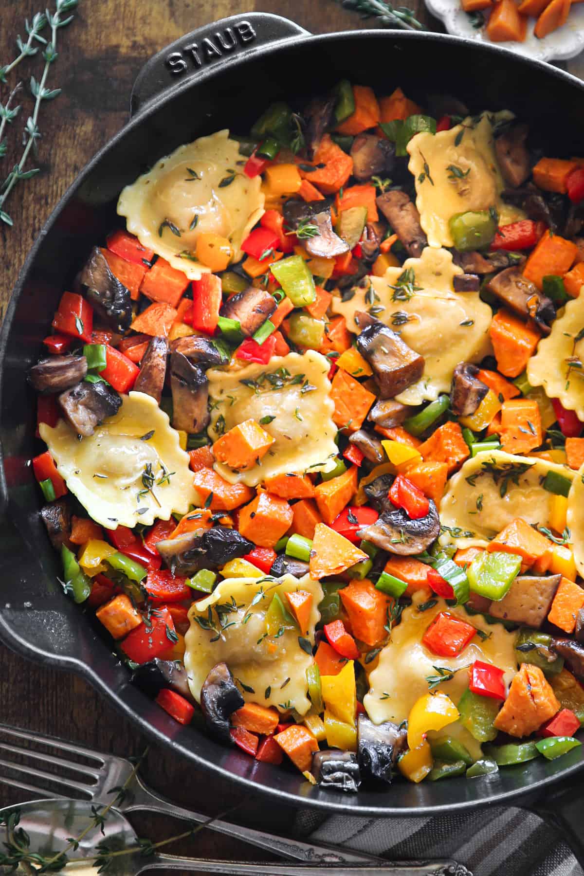 Ravioli with Sweet Potatoes, Portobello Mushrooms, Bell Peppers in a cast iron skillet.