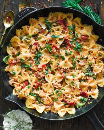 Creamy Sausage and Kale Pasta with Sun-Dried Tomatoes - in a cast iron skillet.