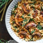Creamy Spinach and Mushroom Orzo - on a white plate.