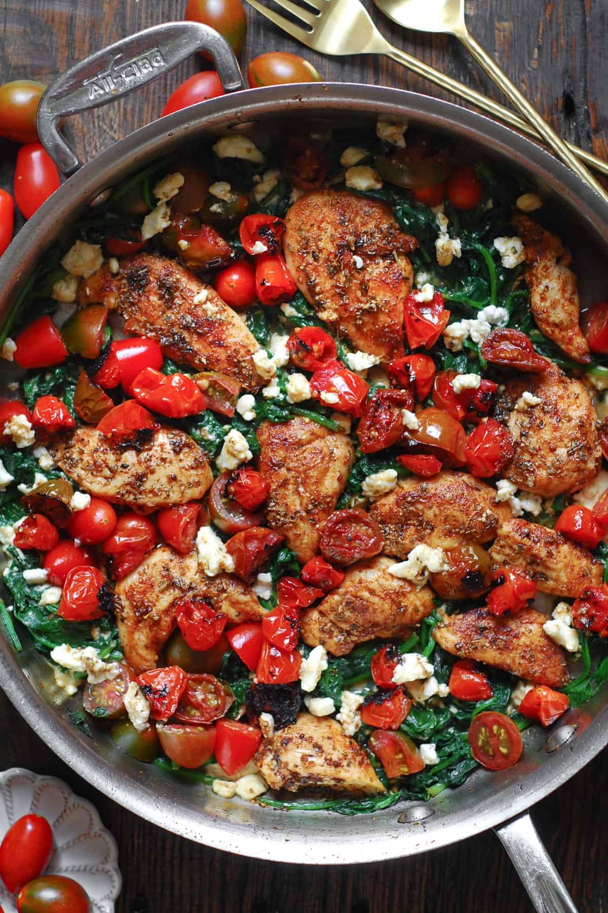 Mediterranean Chicken Stir Fry with Vegetables (Tomatoes and Spinach) and Feta Cheese - in a stainless steel pan.
