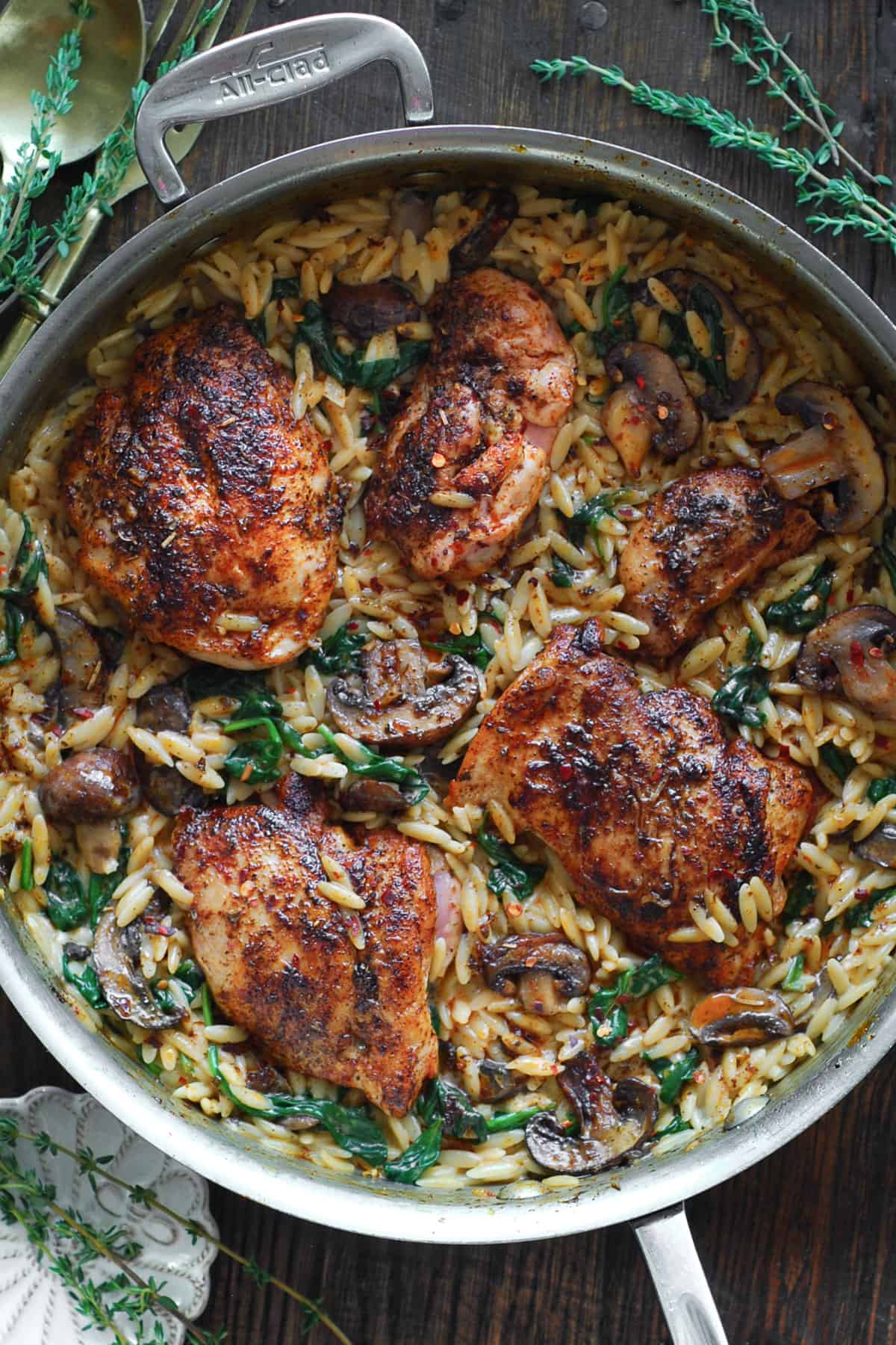 Creamy Chicken Orzo with Mushrooms and Spinach - in a stainless steel pan.