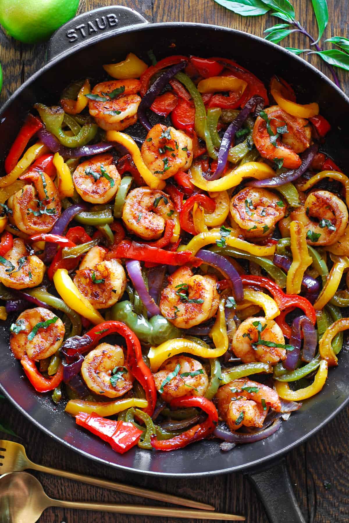 shrimp fajiitas with bell peppers and onions - in a cast iron skillet.