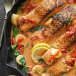 Thai Coconut Curry Salmon with Red Bell Pepper, Spinach, and Bananas - in a cast iron skillet.