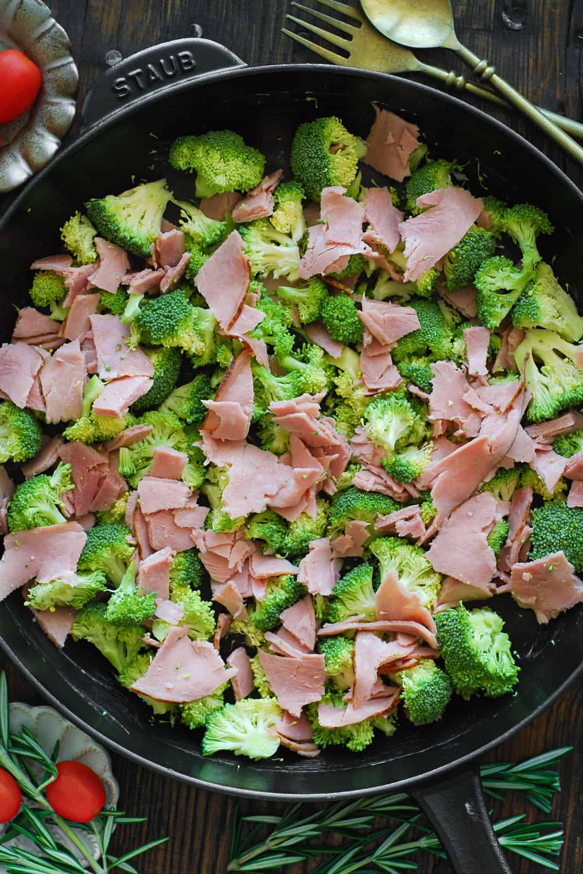 broccoli and ham for frittata in a cast iron skillet.