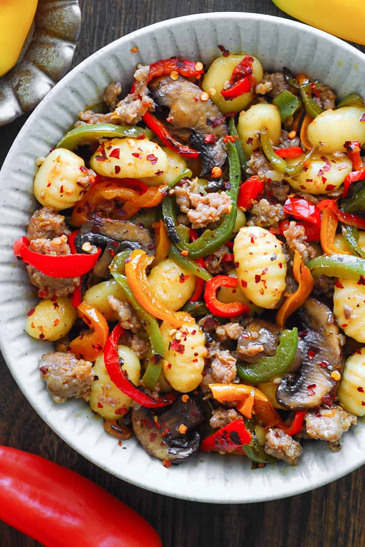 Spicy Italian Sausage Gnocchi with Mushrooms and Bell Peppers - in a white bowl.