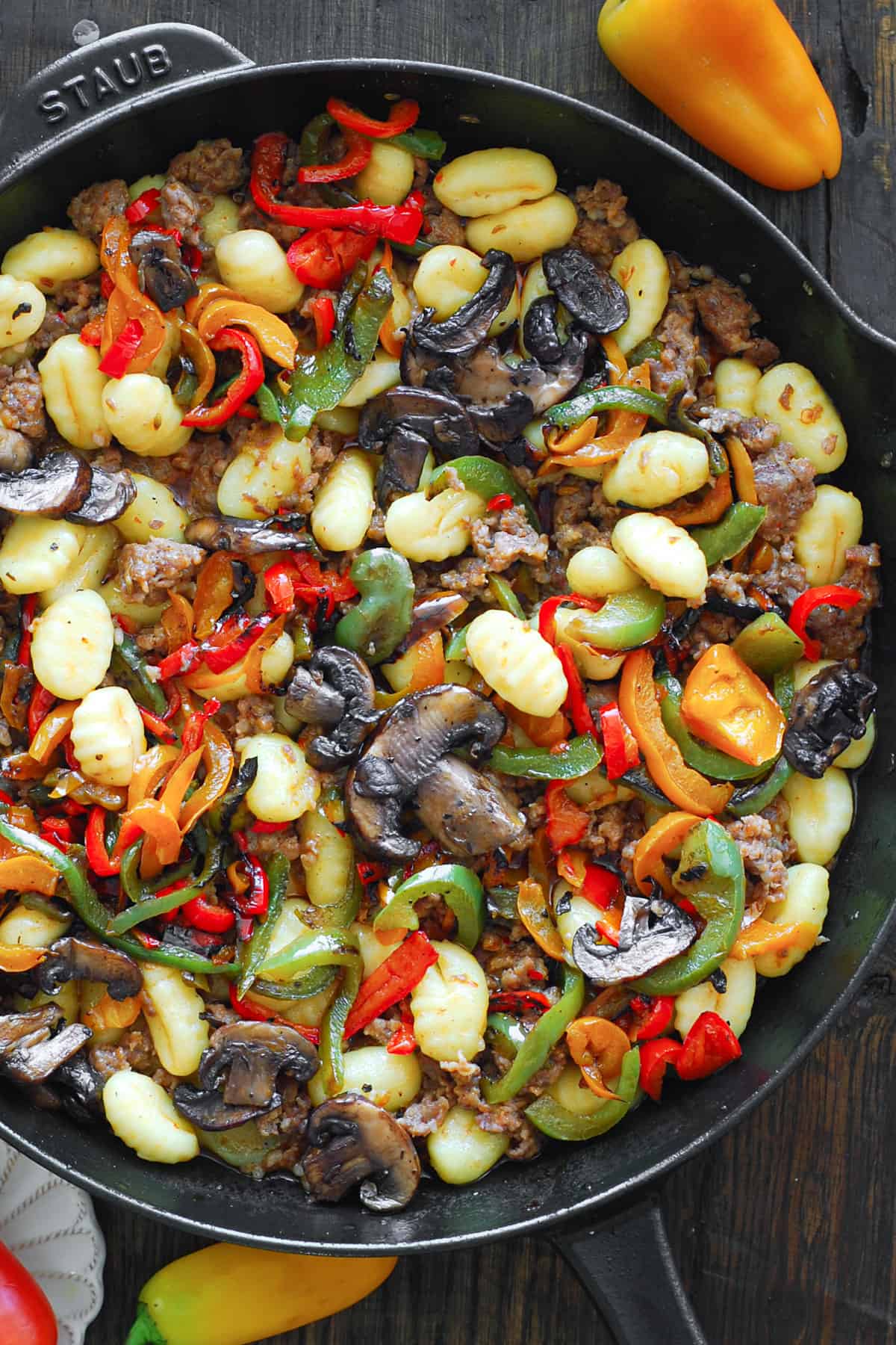 Spicy Italian Sausage Gnocchi with Mushrooms and Bell Peppers - in a cast iron skillet.