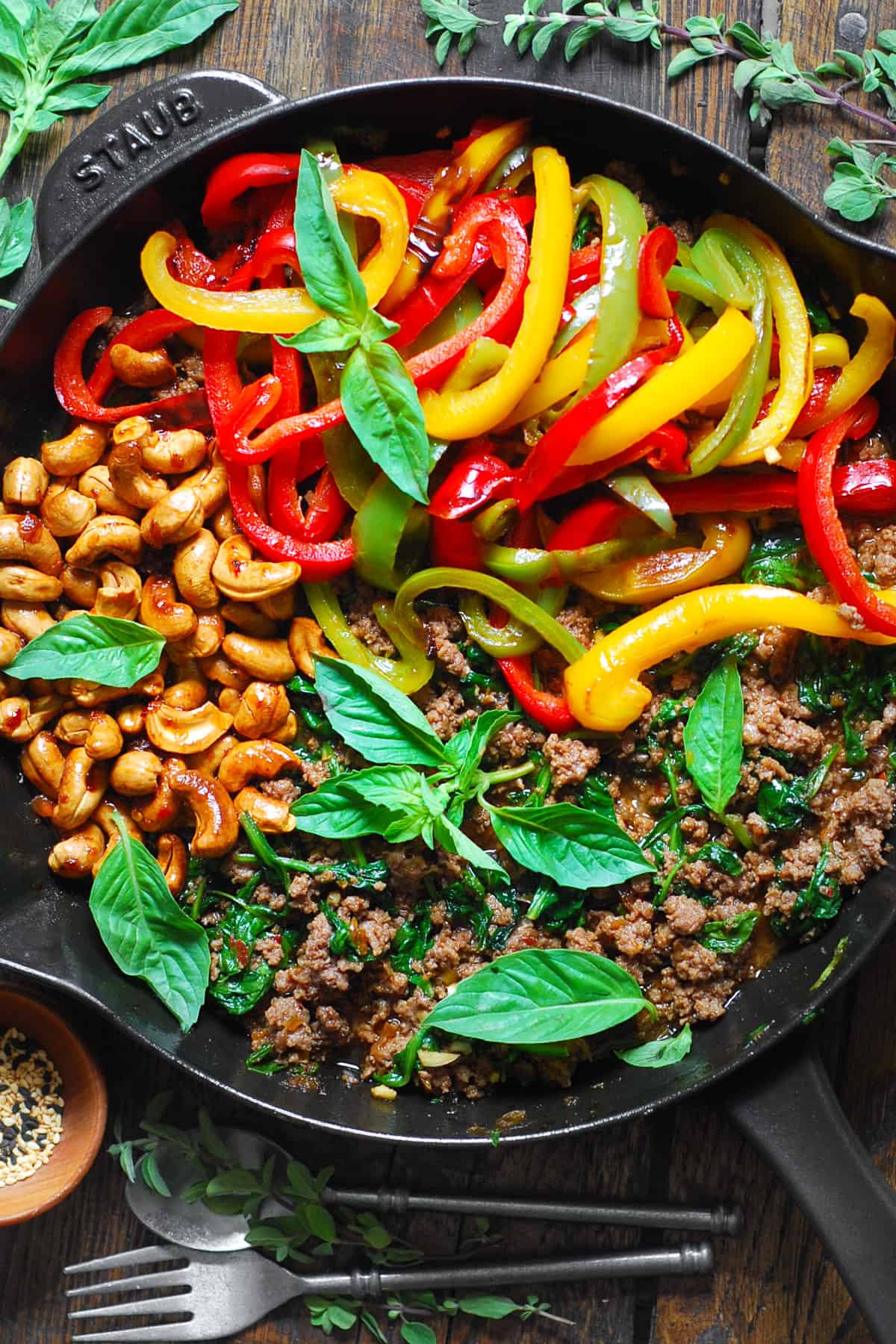 Thai Basil Beef with Bell Peppers and Cashews in a cast iron skillet.
