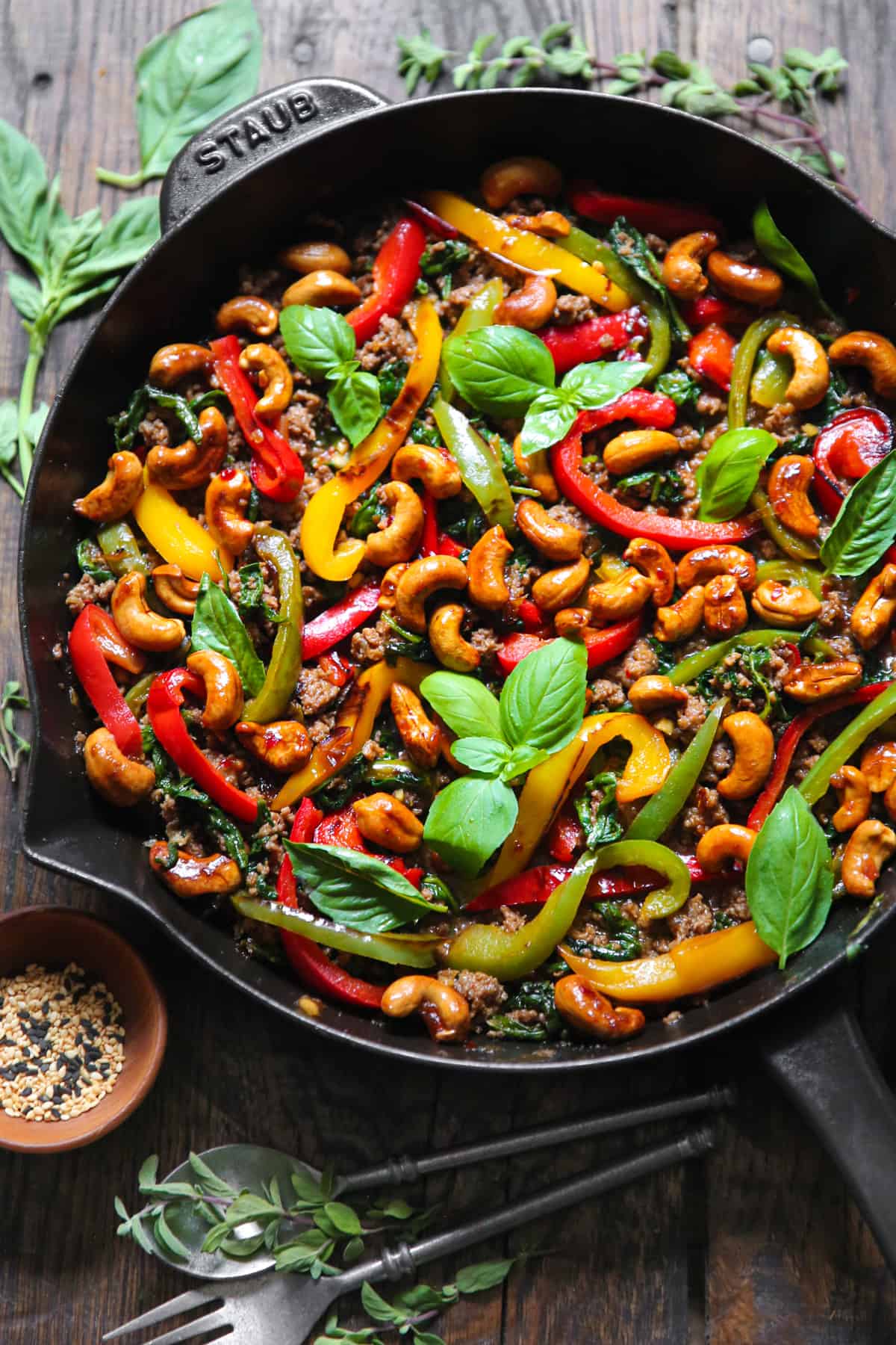 Thai Basil Beef with Bell Peppers and Cashews in a cast iron skillet.