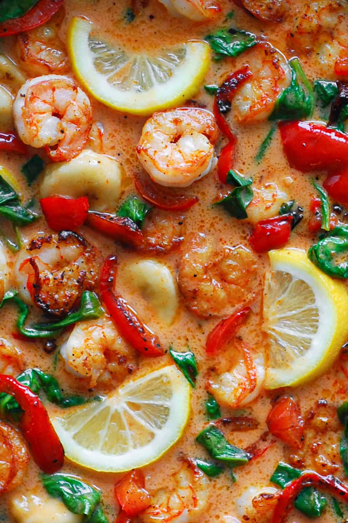 Red Coconut Curry Shrimp with Bananas, Bell Peppers, and Spinach - close-up photo.
