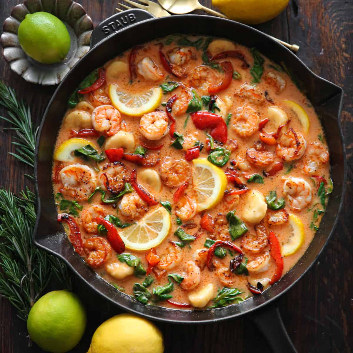 Red Coconut Curry Shrimp with Bananas, Bell Peppers, and Spinach - in a cast iron skillet.