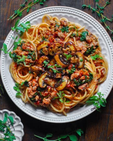 Sausage Mushroom Pasta with Spinach and Tomato Sauce - on a plate.