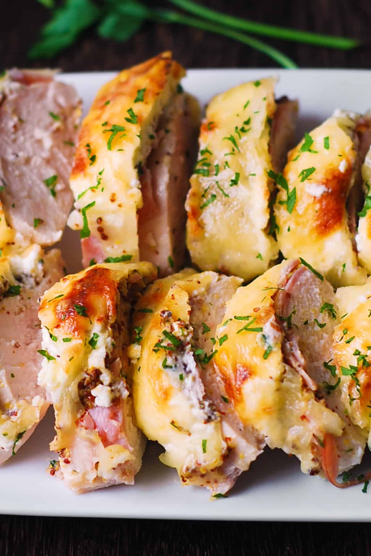 Chicken Cordon Bleu (chicken with layers of ham and Swiss cheese) - sliced on a plate.