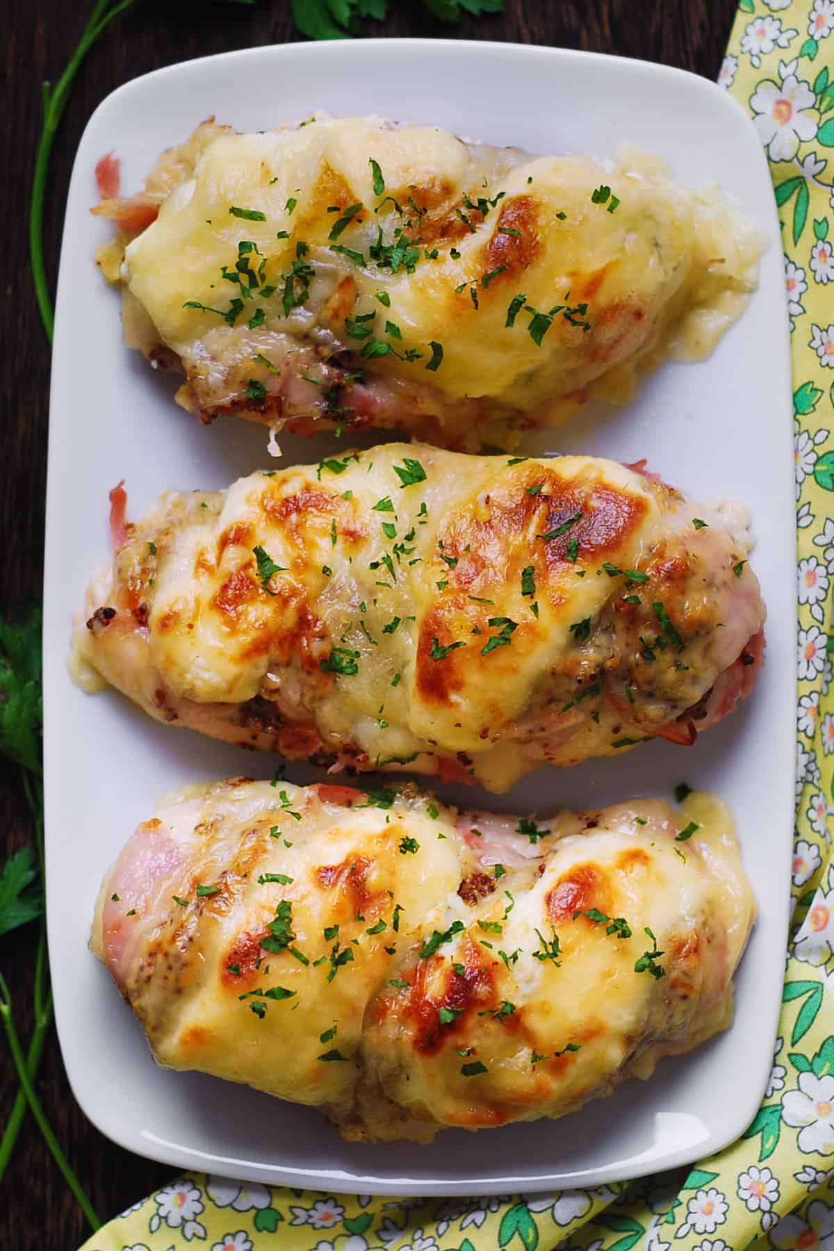 Chicken Cordon Bleu Bake (chicken breasts with layers of ham and Swiss cheese) - on a plate.