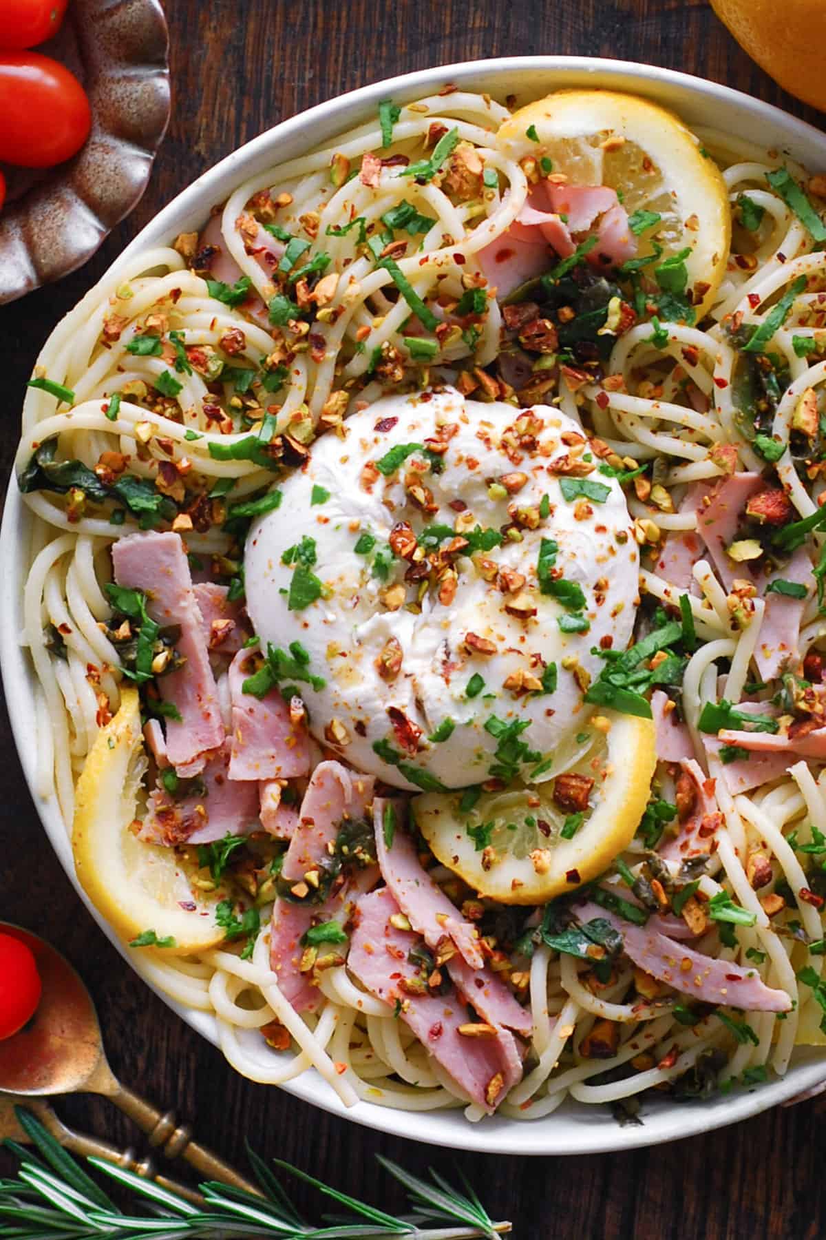 Ham Pasta with Spinach, Burrata Cheese, and Lemon Butter Sauce - in a white bowl.