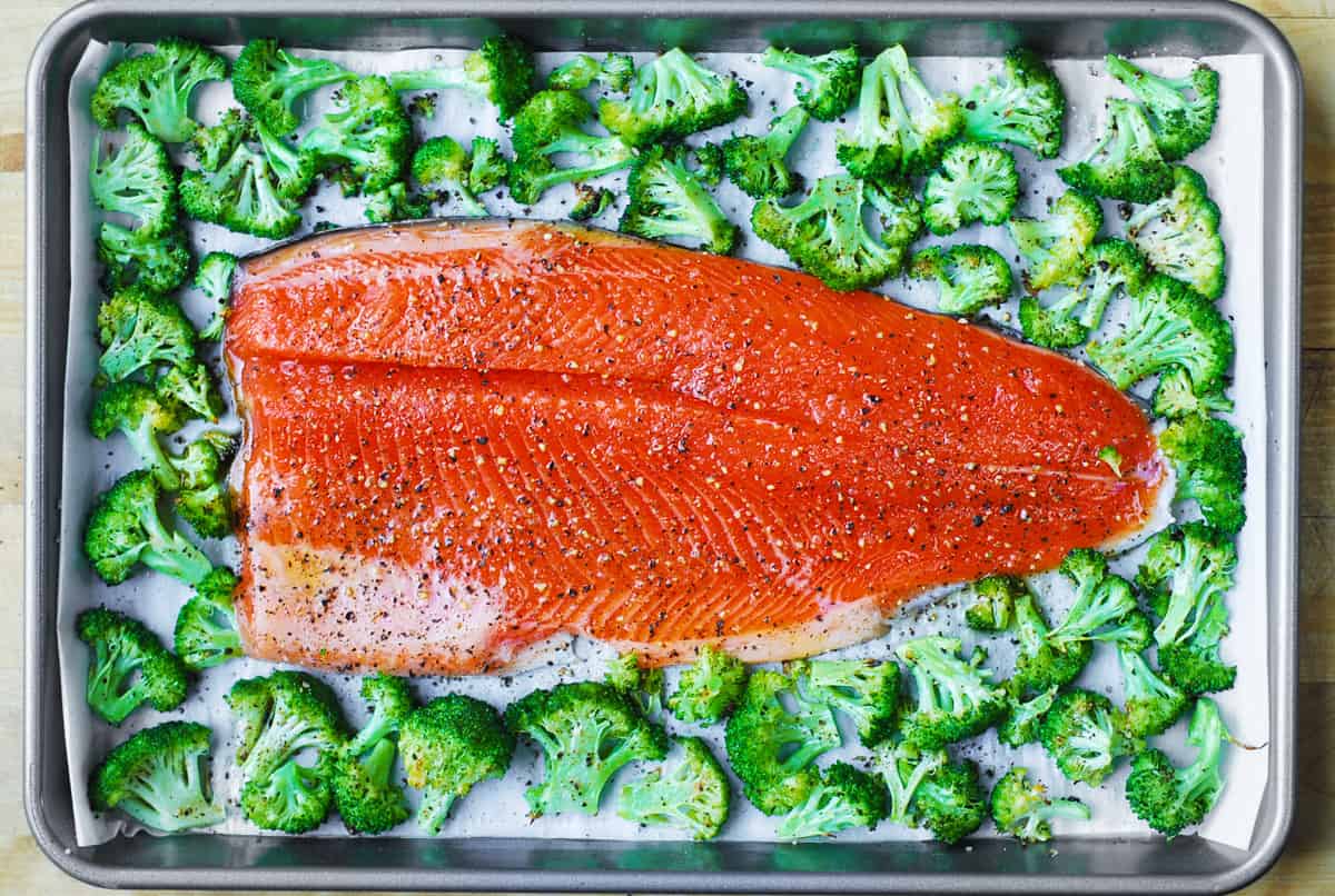 salmon and broccoli (brushed with olive oil and seasoned with salt and pepper) on a sheet pan.