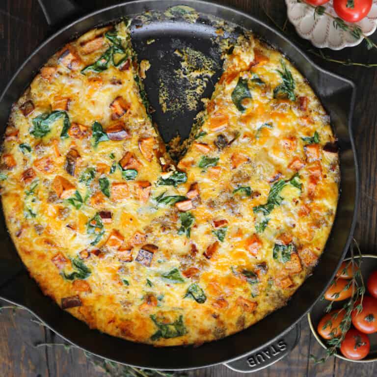 Sweet potato frittata with sausage, spinach, cheddar, and pepper jack cheese - in a cast iron skillet.