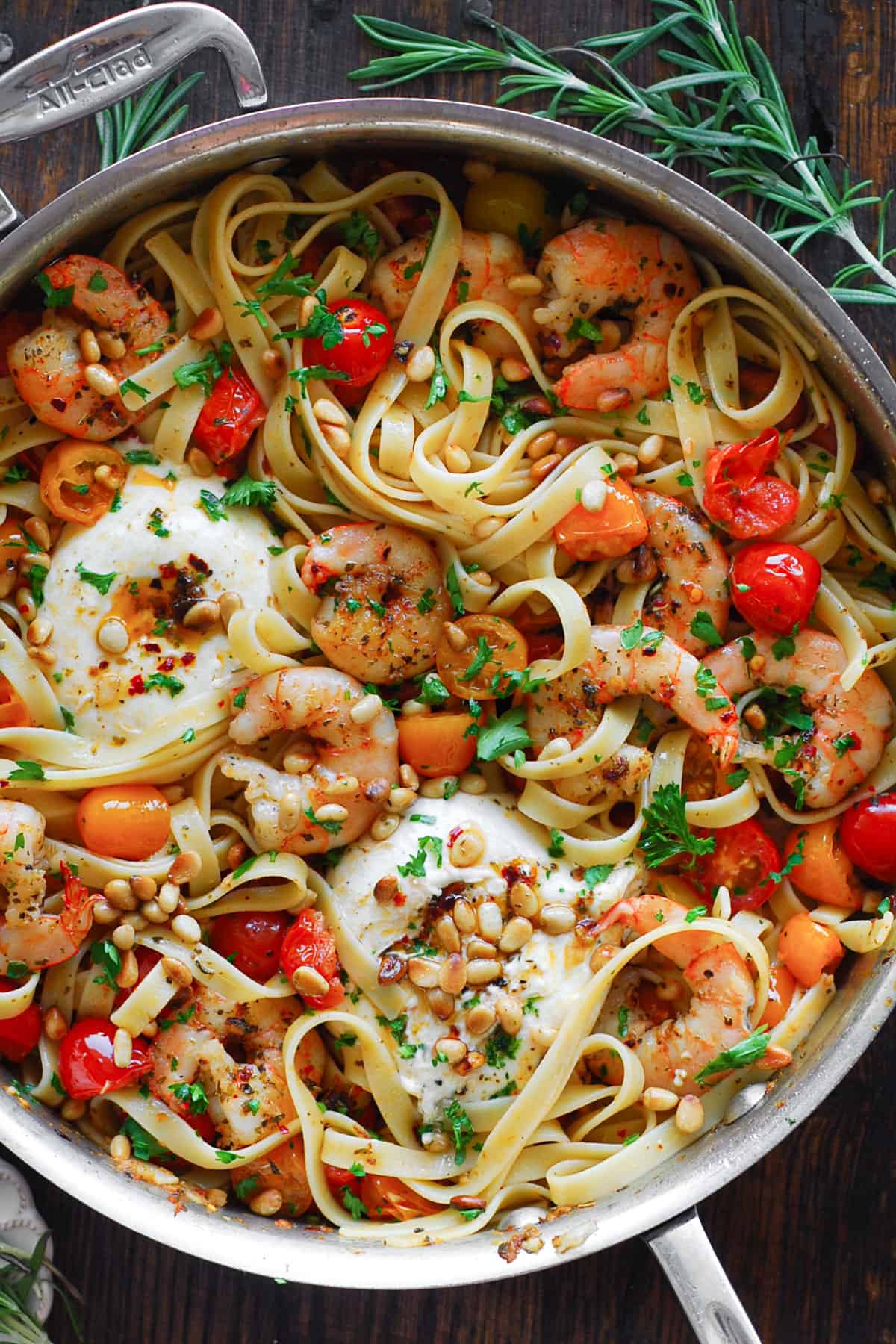 Mediterranean Shrimp Pasta with Cherry Tomatoes, Burrata Cheese, and Pine Nuts - in a stainless steel skillet.