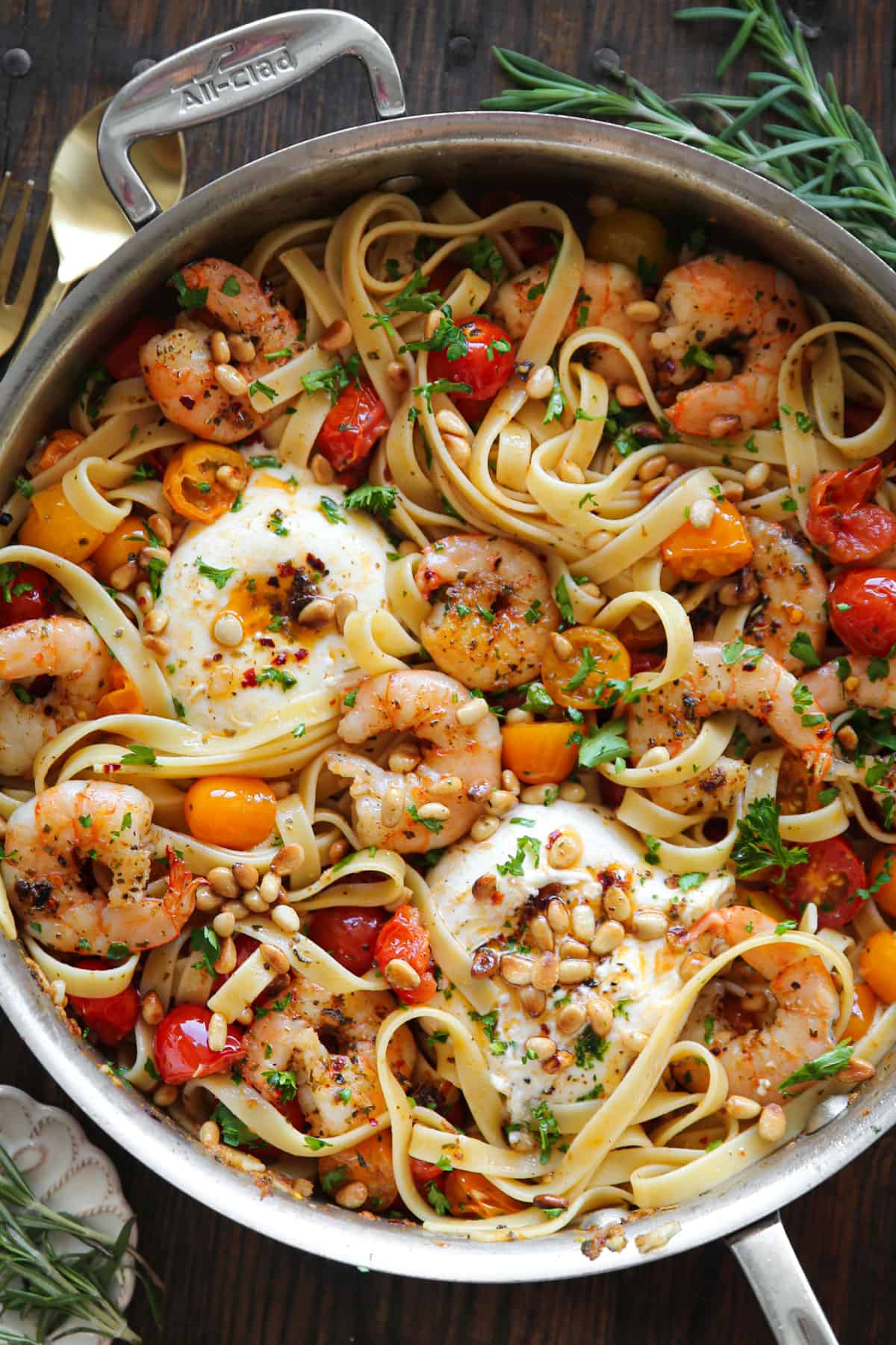 Mediterranean Shrimp Pasta with Cherry Tomatoes, Burrata Cheese, and Pine Nuts - in a stainless steel skillet.