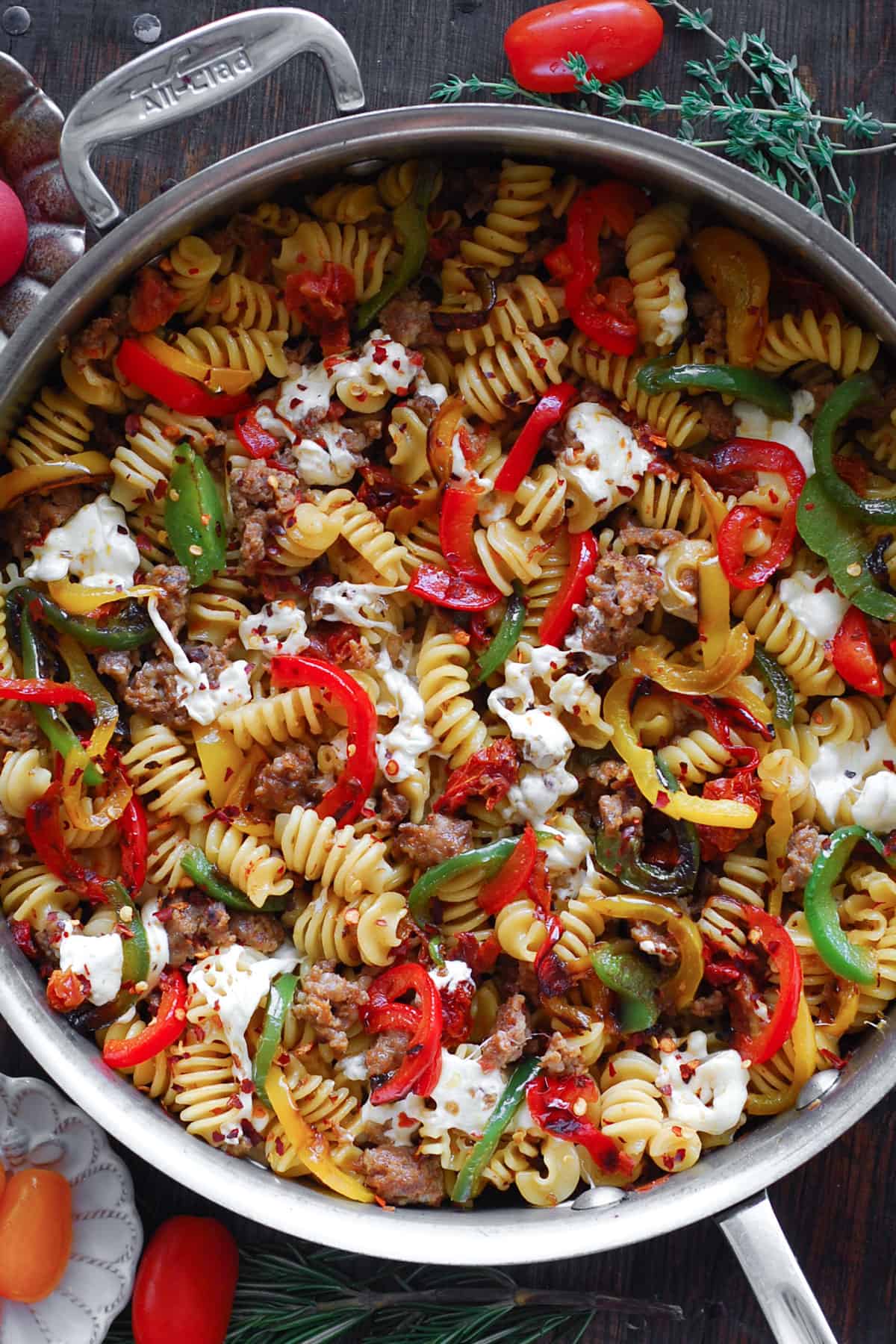 Pasta with Sausage and Peppers, Sun-Dried Tomatoes, and fresh Mozzarella cheese - in a stainless steel pan.