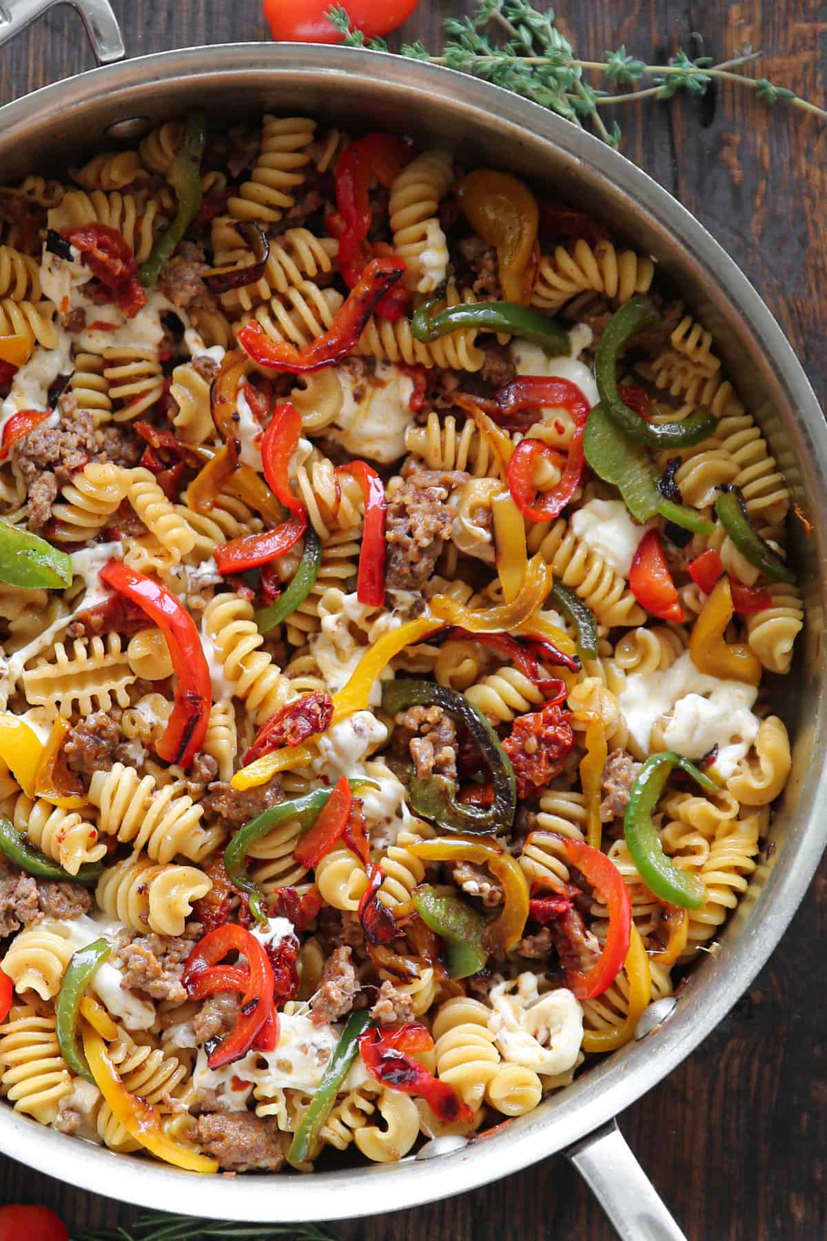 Pasta with Sausage and Peppers, Sun-Dried Tomatoes, and fresh Mozzarella cheese - in a stainless steel pan.
