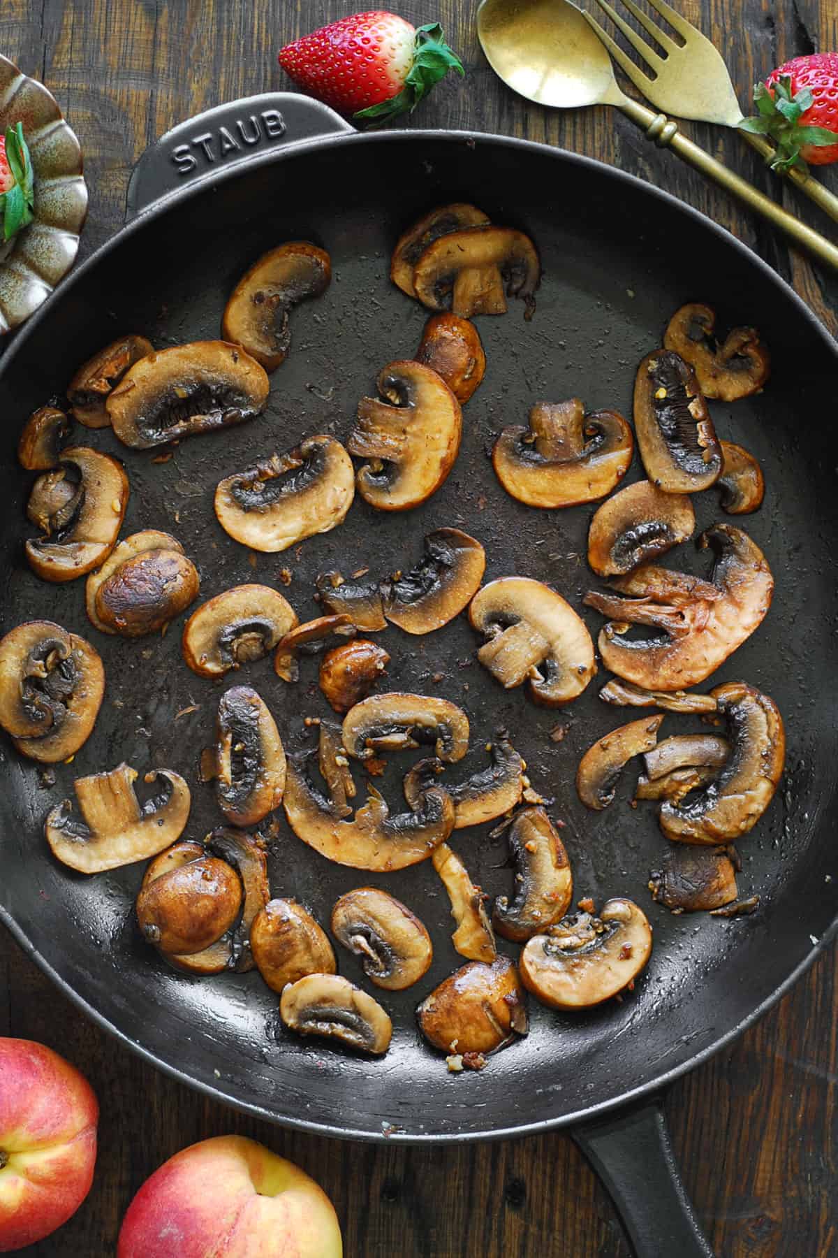 cooked sliced mushrooms in a cast iron skillet