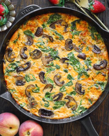 sausage frittata with spinach and mushrooms - in a cast iron skillet.