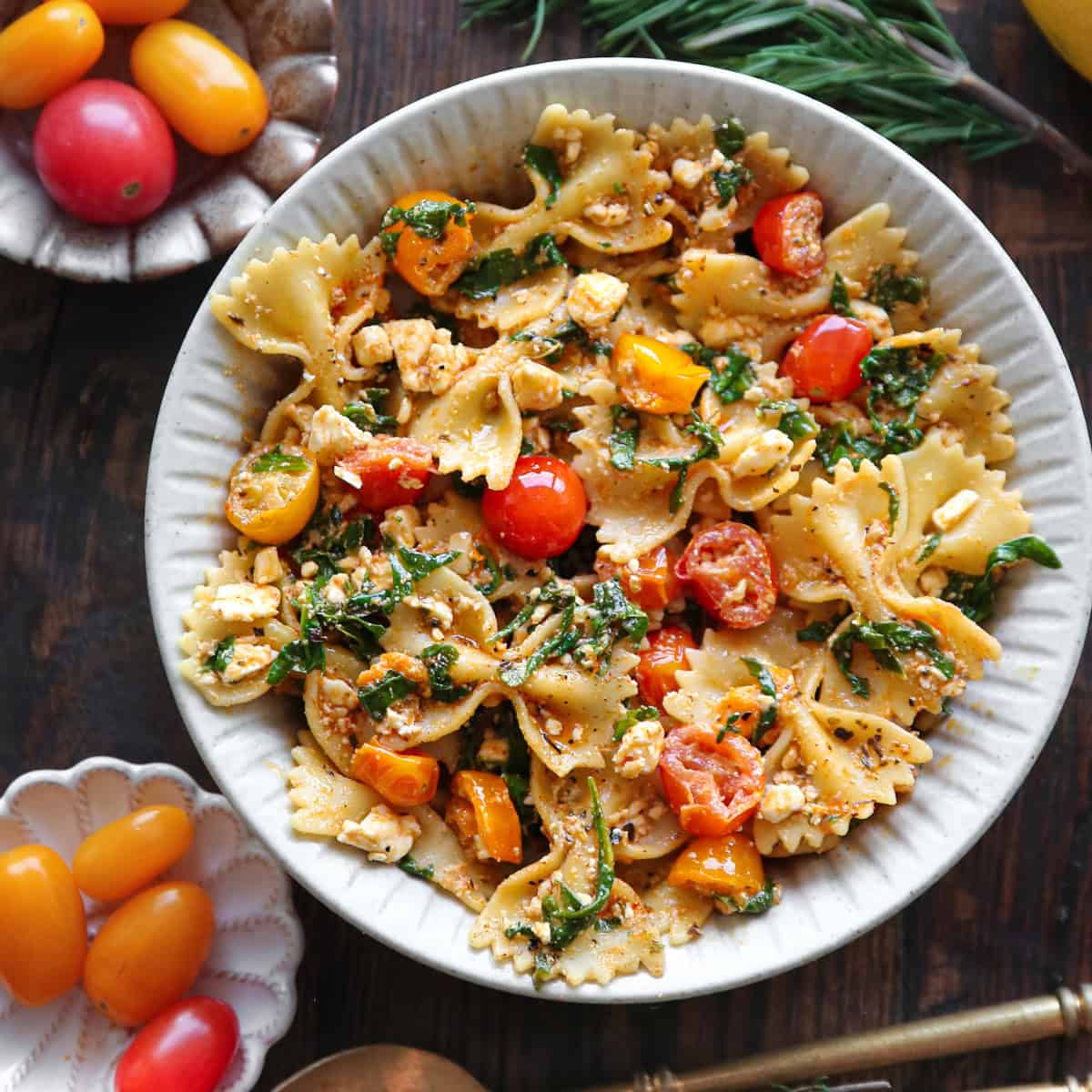 Pasta with Feta Cheese, Cherry Tomatoes, Spinach - in a white bowl.