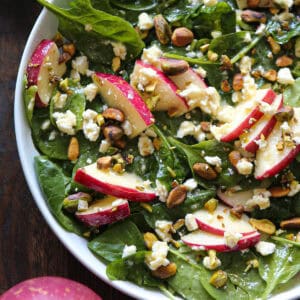 Apple Spinach Salad with Feta, Pistachios, and Honey-Mustard Lemon Dressing - in a white bowl.