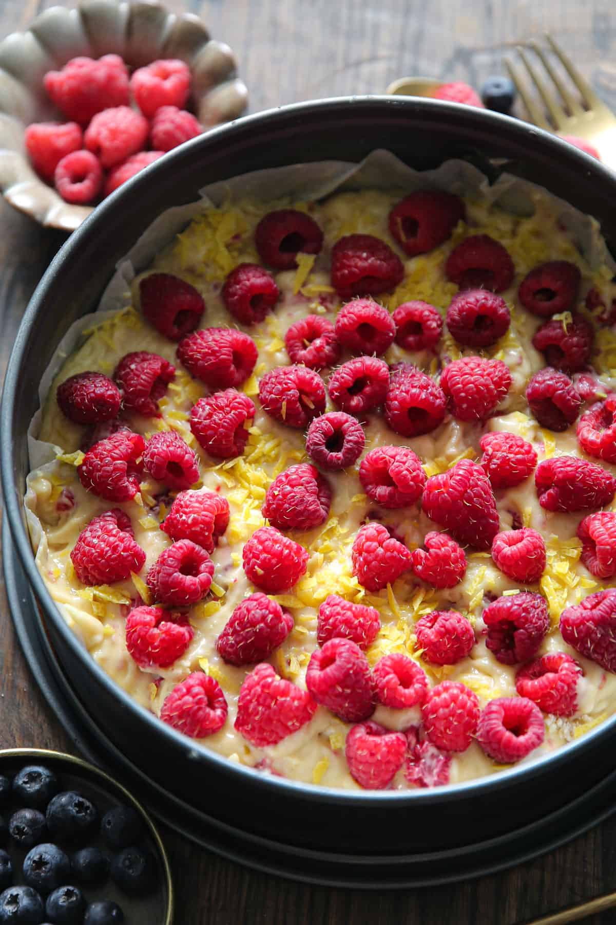 fresh raspberries and cake batter in a springform pan.