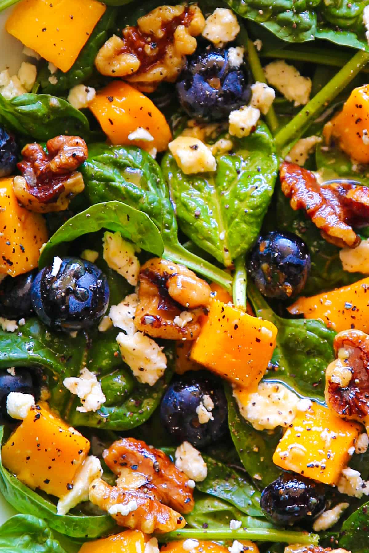 Mango Salad with Spinach, Blueberries, Walnuts, and Feta Cheese - close-up photo.
