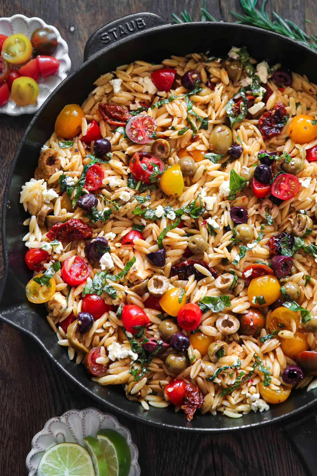 Greek Orzo with Tomatoes, Feta, and Olives - in a cast iron skillet.