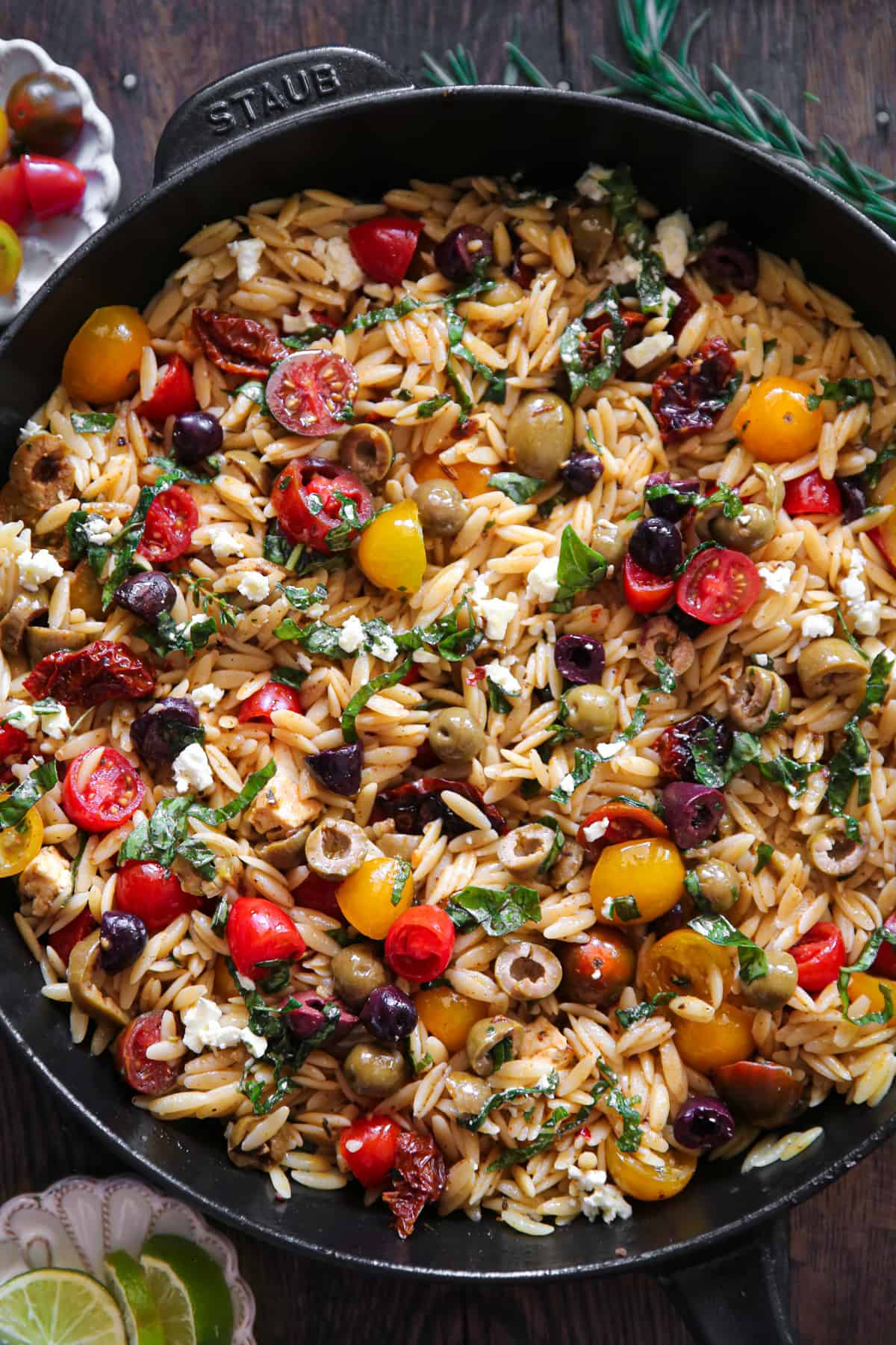 Greek Orzo with Tomatoes, Feta, and Olives - in a cast iron skillet.