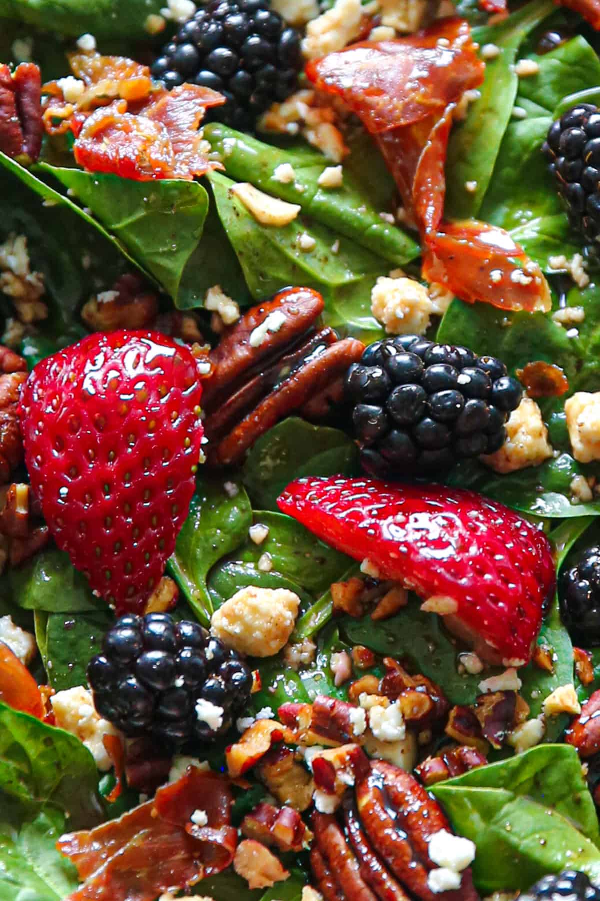 Berry spinach salad with strawberries, blackberries, feta cheese, pecans, crispy prosciutto, and balsamic glaze.