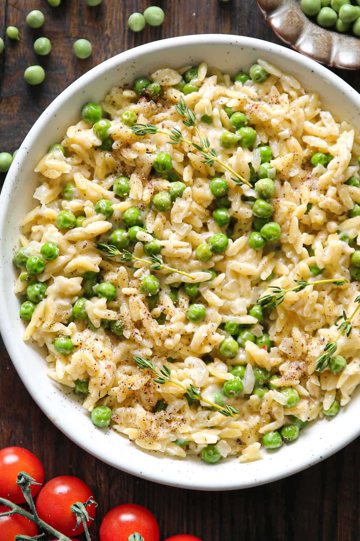 Creamy Garlic Parmesan Orzo with Green Peas - in a white bowl.