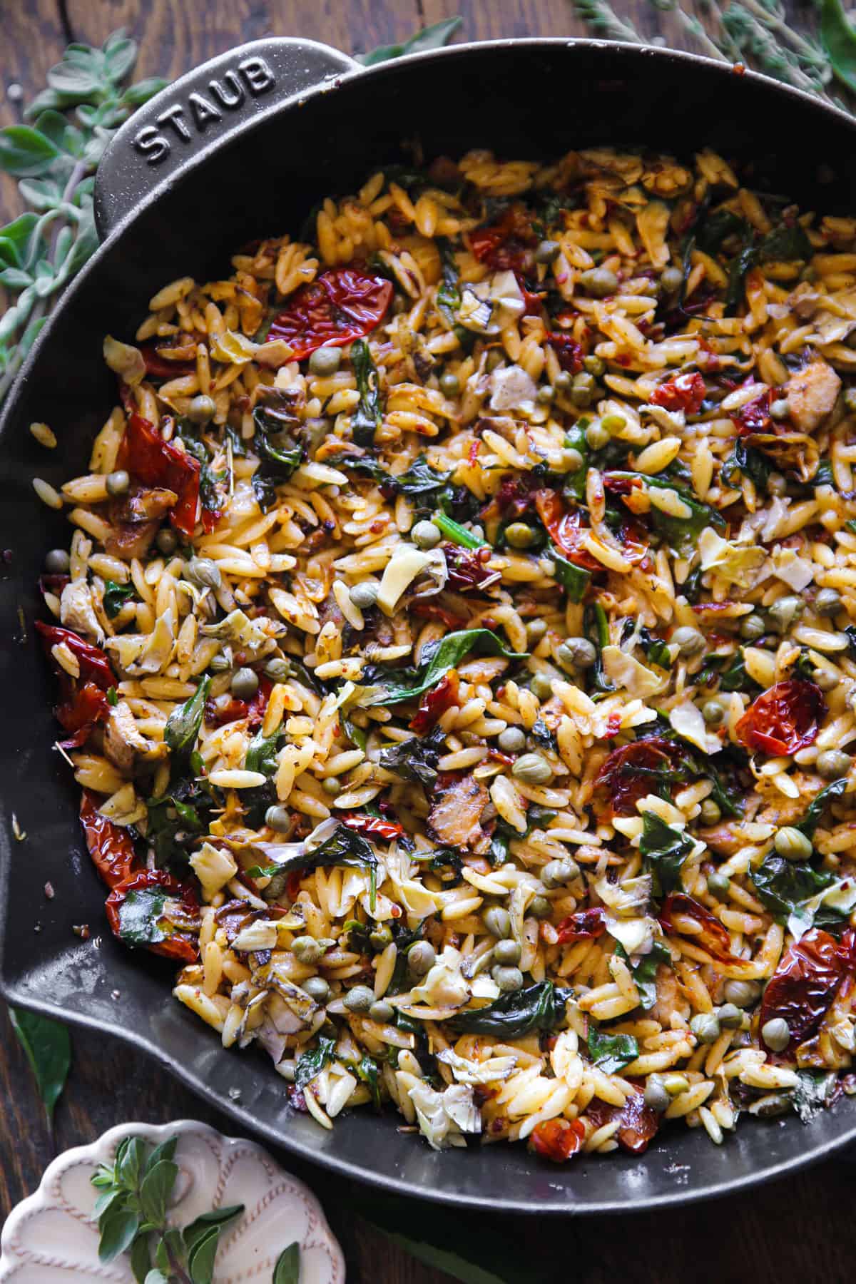 Sun-Dried Tomato and Spinach Orzo with Artichokes and Capers - in a cast iron skillet.