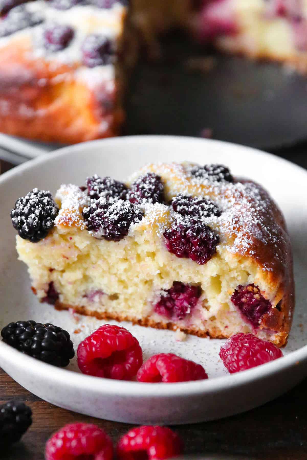 a sliced of blackberry cake on a plate.