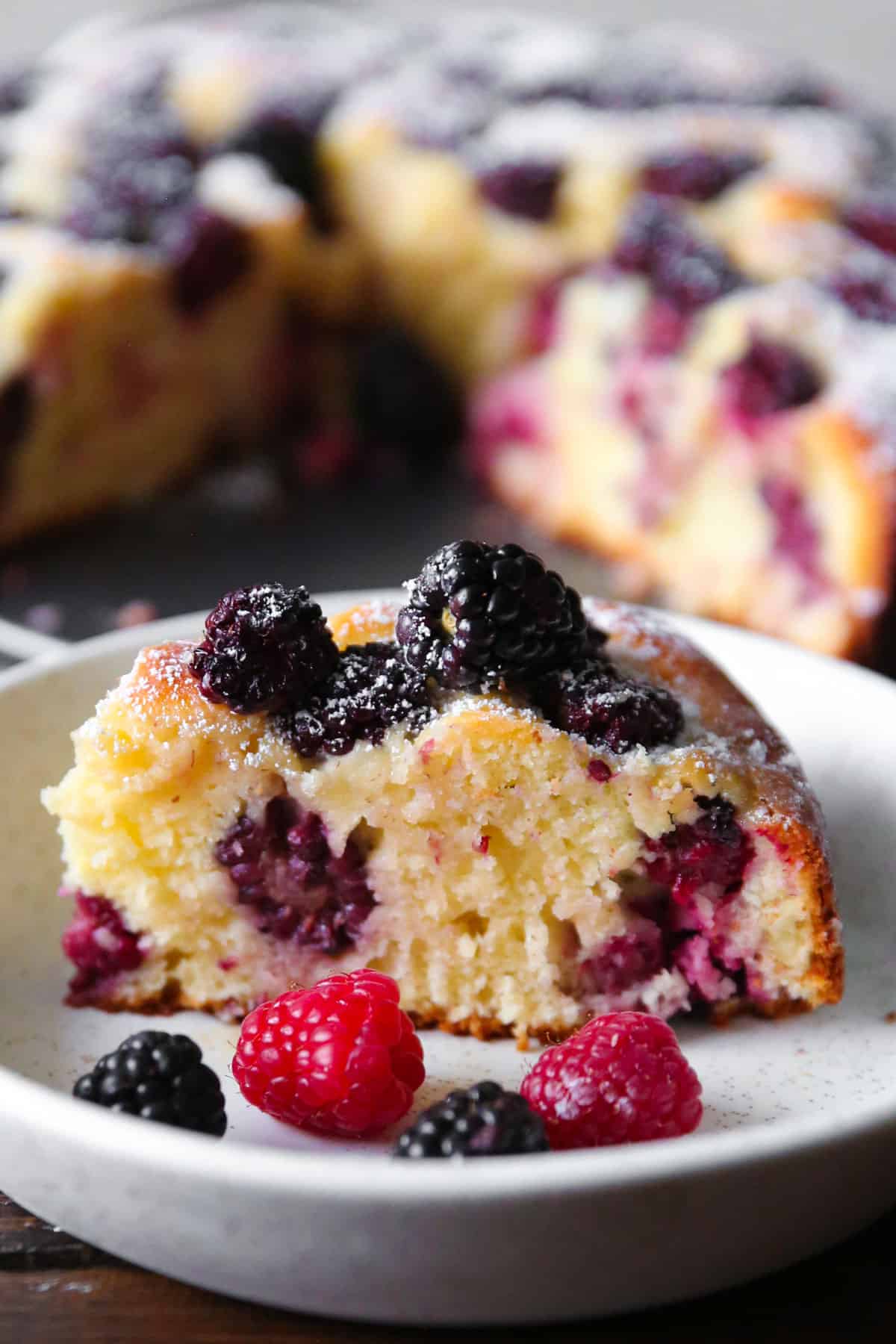 a slice of blackberry cake on a plate.