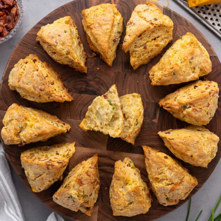 Savory Bacon & Cheddar Cheese Scones - on a round wooden board.