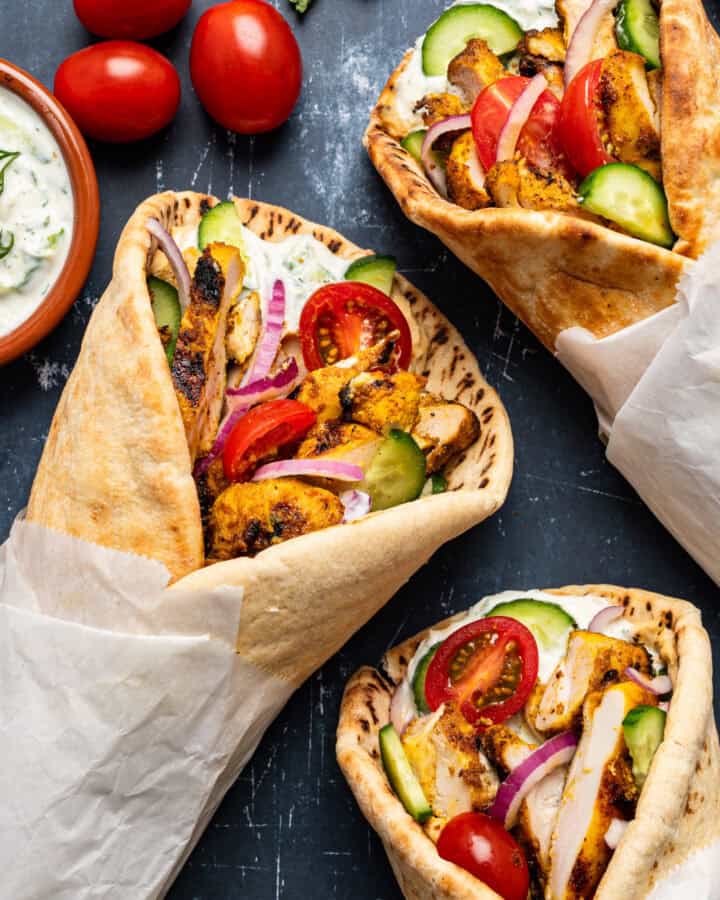 Chicken Shawarma Wraps with pita bread, tomatoes, cucumber, and tzatziki sauce.