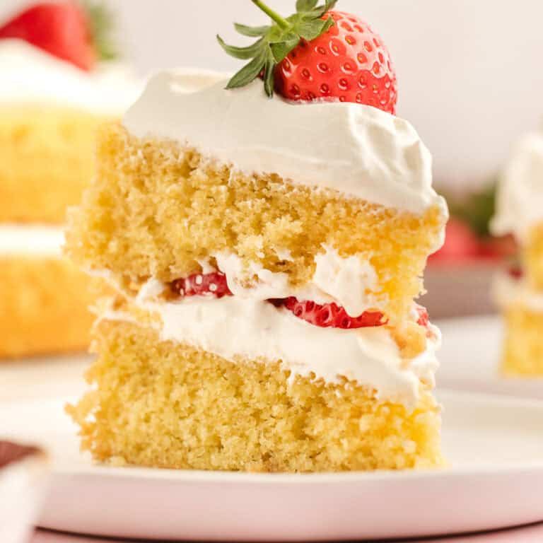 A slice of strawberry shortcake cake on a plate.