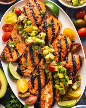 Grilled Salmon Fillets with Pineapple Tomato Avocado Salsa - on a large white platter.